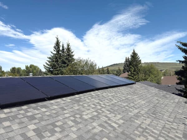 Solar panels on residential rooftop under blue sky
