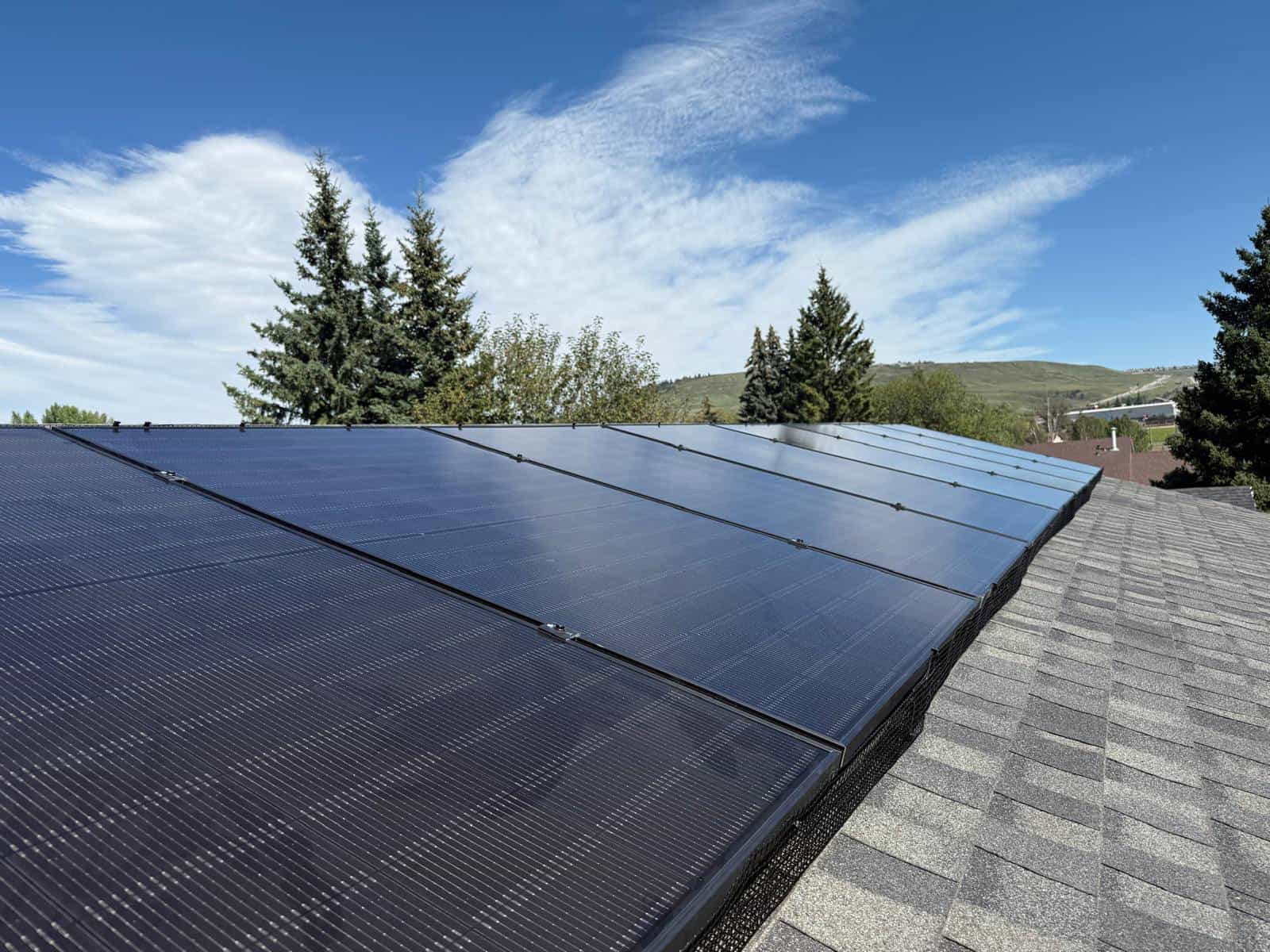 Solar panels on house roof under blue sky