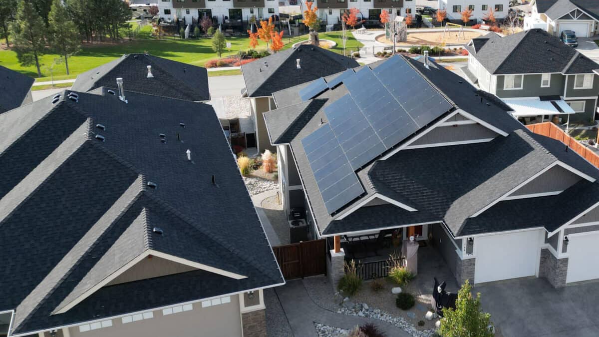 Aerial view of a residential home in the Okanagan with solar panels installed on the roof, showcasing Solos Energy's solar energy solutions for homes.